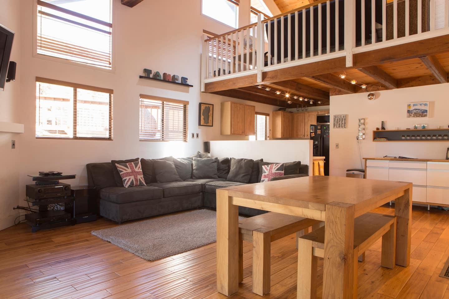 Dining table set for eight beside the open-plan living room