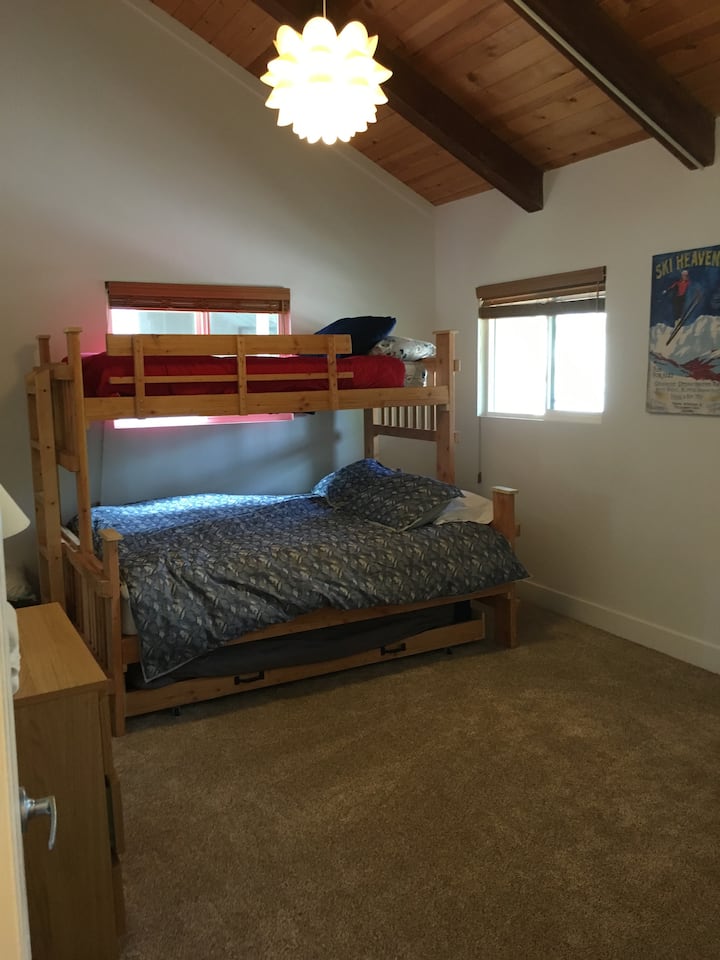 Front bedroom with a queen bed, a trundle bed underneath and a single top bunk