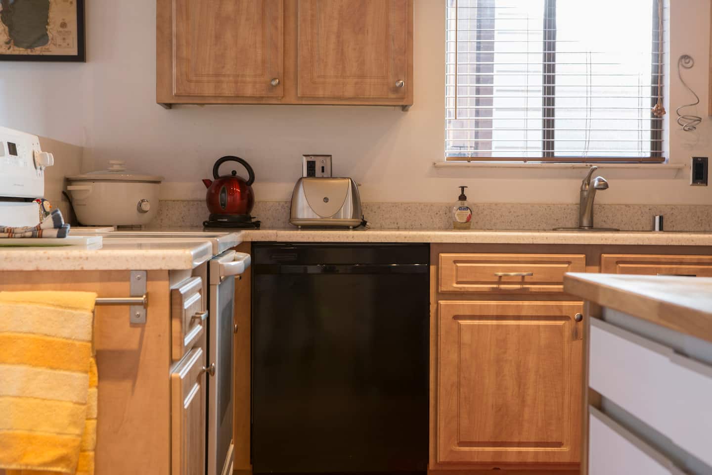 Kitchen with wooden cabinets, oven and full worktop