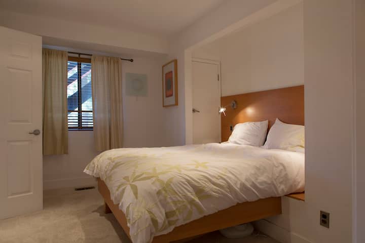 Downstairs bedroom with a queen bed and an en-suite bathroom